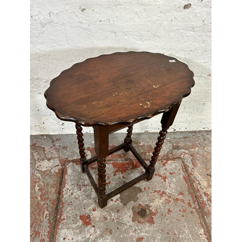 107 - An oak pie crust edge oval side table on barley twist supports - approx. 64cm high x 37cm wide x 55c... 
