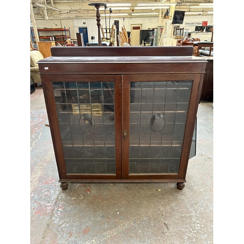 113 - An Aw-Lyn mahogany display cabinet with two leaded glass doors and three internal shelves - approx. ... 