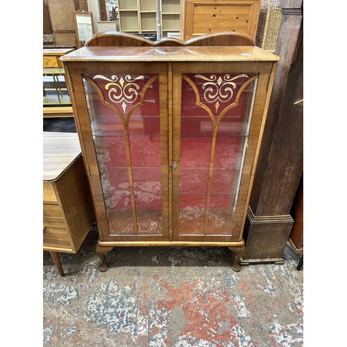 15 - A walnut display cabinet with two glazed doors, two glass shelves and cabriole supports - approx. 12... 