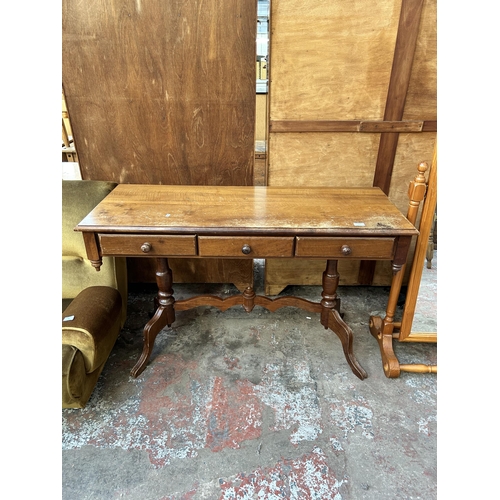 71 - A Victorian style pine effect rectangular twin pedestal console table with three drawers - approx. 7... 