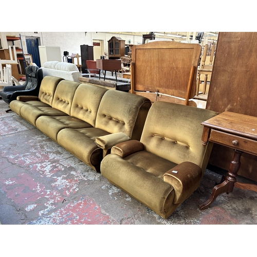 72 - A mid 20th century green fabric upholstered two piece lounge suite comprising modular four seater so... 