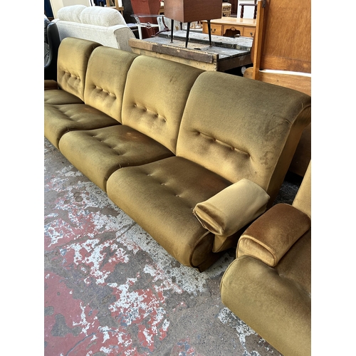 72 - A mid 20th century green fabric upholstered two piece lounge suite comprising modular four seater so... 