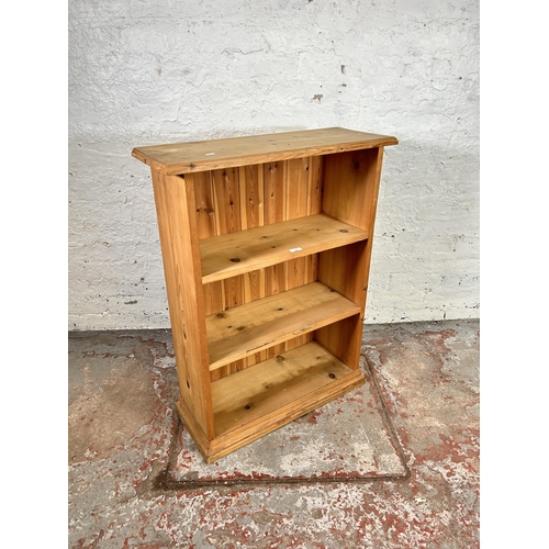 76 - A pine three tier open free standing bookcase - approx. 93cm high x 71cm wide x 27cm deep