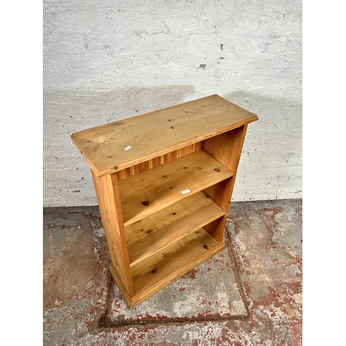 76 - A pine three tier open free standing bookcase - approx. 93cm high x 71cm wide x 27cm deep