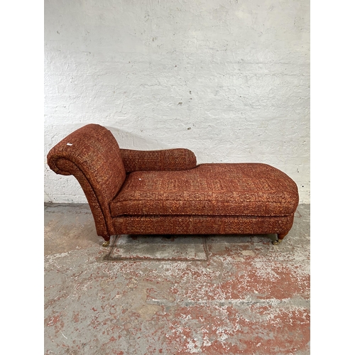 80 - A Victorian style fabric upholstered chaise longue with turned hardwood supports and brass castors -... 