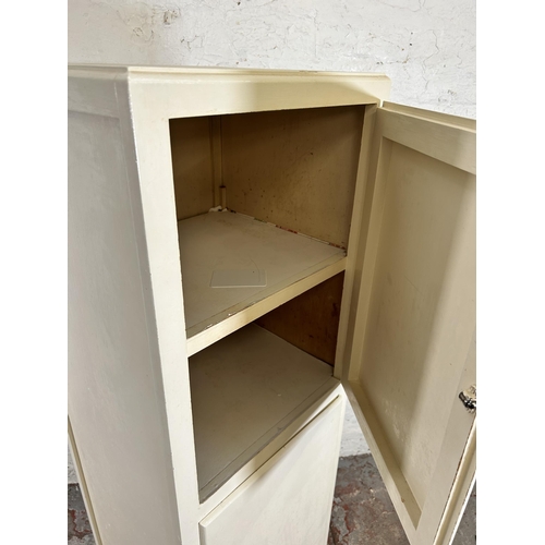 81 - A late 20th century white painted two door cabinet - approx. 140cm high x 43cm wide x 39cm deep