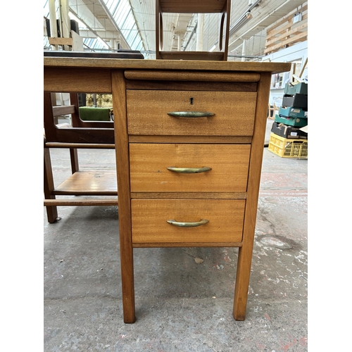 88 - A mid 20th century teak office desk with three drawers - approx. 76cm high x 107cm wide x 61cm deep