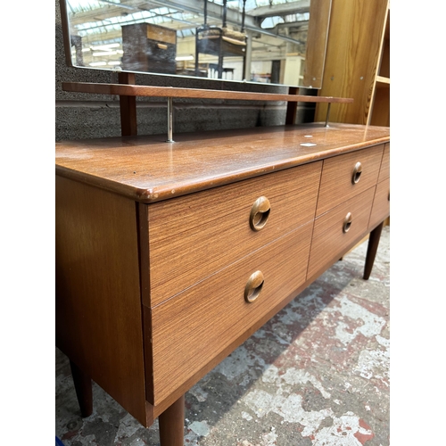 20 - A mid 20th century teak dressing table with six drawers and upper mirror - approx.