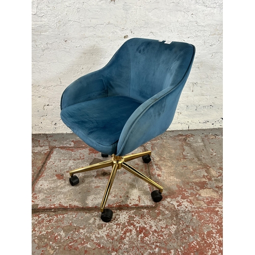 32 - A modern teal velvet and brass effect swivel desk chair
