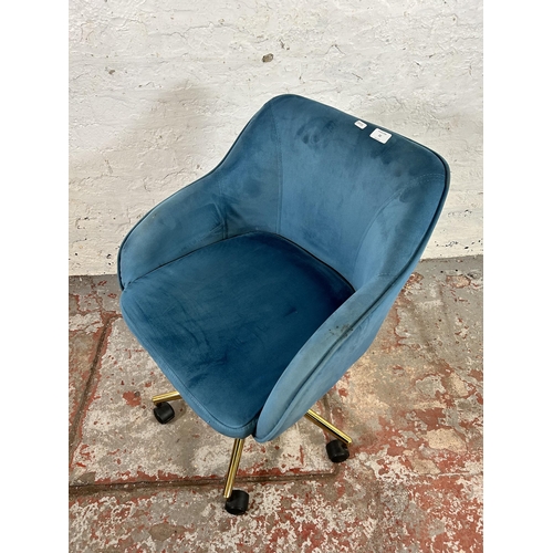 32 - A modern teal velvet and brass effect swivel desk chair