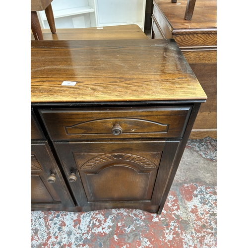 37 - An oak sideboard with two drawers and two cupboard doors - approx. 82cm high x 92cm wide x 40cm deep