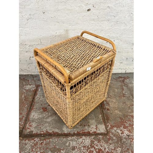 39 - A wicker and bamboo twin handled laundry basket - approx. 67cm high x 50cm wide x 43cm deep