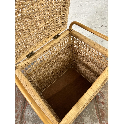 39 - A wicker and bamboo twin handled laundry basket - approx. 67cm high x 50cm wide x 43cm deep