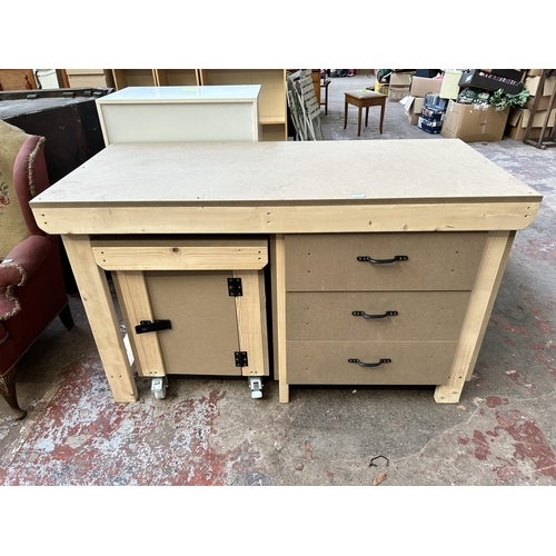 41 - A pine and MDF work bench with three drawers and matching cabinet on castors - approx. 90cm high x 1... 
