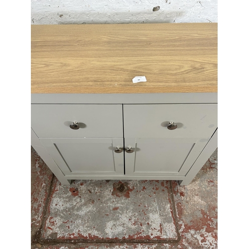 49 - A modern oak effect and dove grey painted sideboard with two drawers and two cupboard doors - approx... 