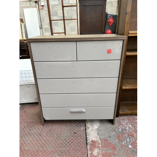 59 - A Rauch oak effect and grey glass chest of two short over four long drawers - approx. 113cm high x 9... 