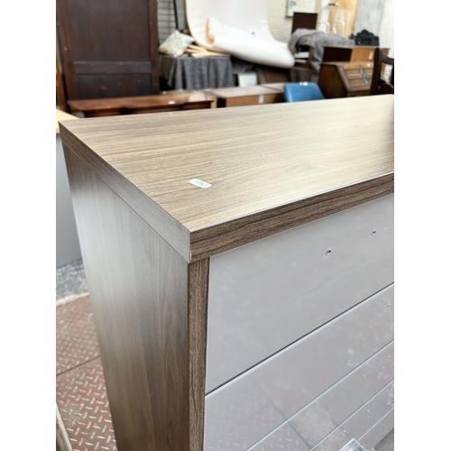 59 - A Rauch oak effect and grey glass chest of two short over four long drawers - approx. 113cm high x 9... 