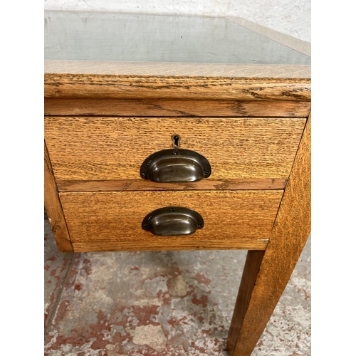 62 - A George VI oak office desk with four drawers and green writing surface - approx. 77cm high x 152cm ... 