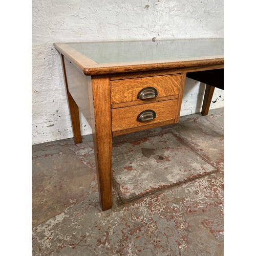62 - A George VI oak office desk with four drawers and green writing surface - approx. 77cm high x 152cm ... 
