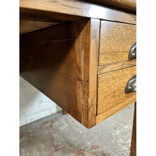 62 - A George VI oak office desk with four drawers and green writing surface - approx. 77cm high x 152cm ... 