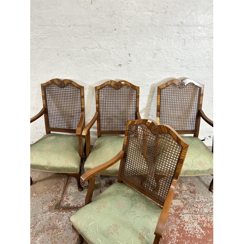 63 - A set of four walnut and rattan bergere armchairs with green floral upholstery