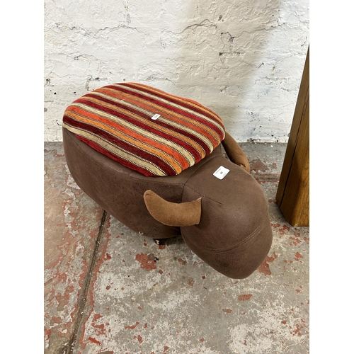 64 - Two items, one modern brown faux suede and fabric upholstered bull footstool and one solid oak mante... 
