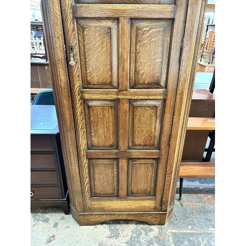 7 - A carved oak single door wardrobe with fitted interior - approx. 184cm high x 79cm wide 41cm deep