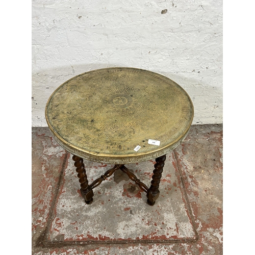 140 - A Middle Eastern travel table with wooden barley twist folding base and brass circular tray - approx... 