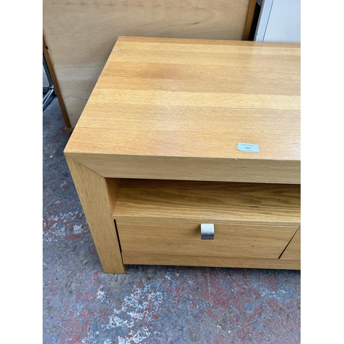 143 - A modern oak effect TV stand with two drawers - approx. 50cm high x 100cm wide x 60cm deep