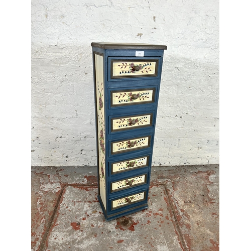 146 - A hand painted wooden chest of seven drawers with floral design - approx. 96cm high x 28cm wide x 22... 