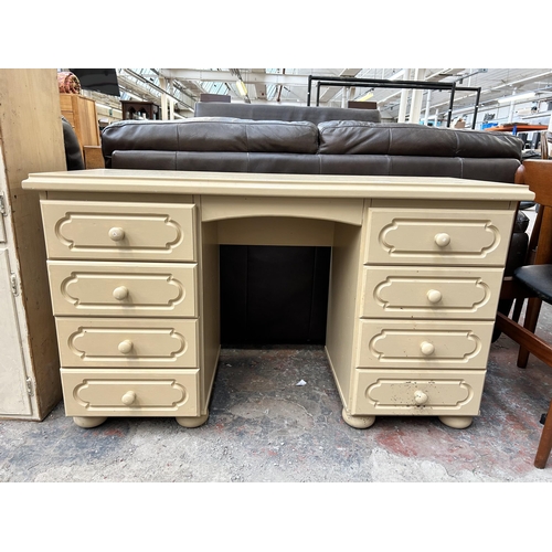 151 - A modern cream painted dressing table with eight drawers