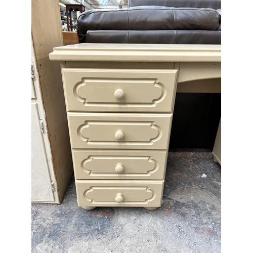 151 - A modern cream painted dressing table with eight drawers