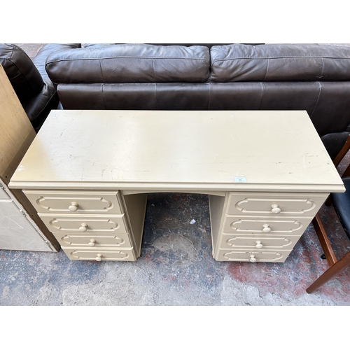 151 - A modern cream painted dressing table with eight drawers