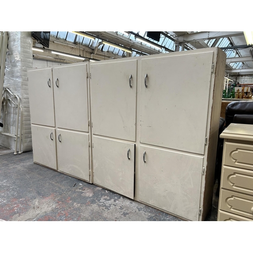 152 - Two mid 20th century white painted four door kitchen cabinets - approx. 120cm high x 106cm wide x 31... 