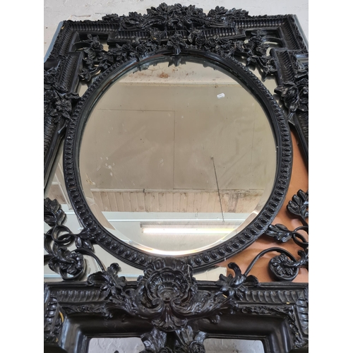 170 - A Victorian style black framed bevelled wall mirror - approx. 140cm high x 101cm wide