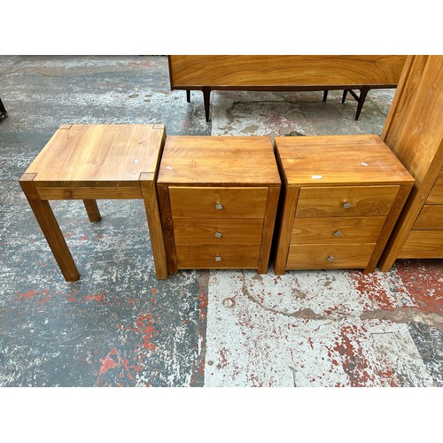 166 - Three pieces of modern teak furniture, two bedside chests of three drawers and one side table