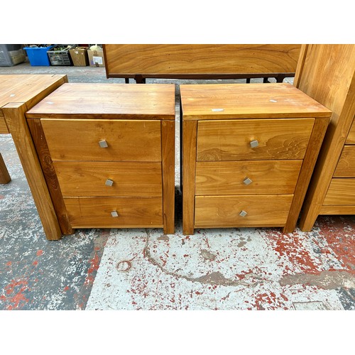 166 - Three pieces of modern teak furniture, two bedside chests of three drawers and one side table