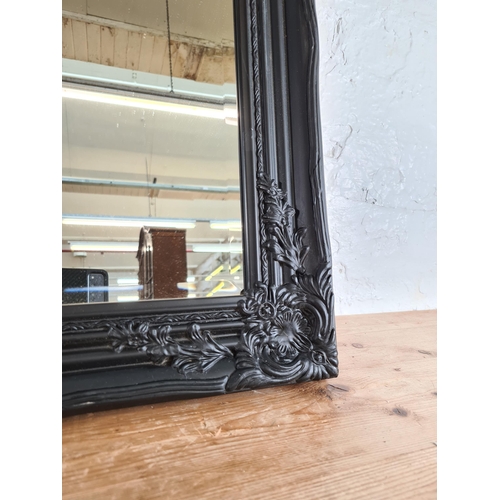 184 - A 19th century style black framed bevelled edge wall mirror - approx. 94cm high x 74cm wide