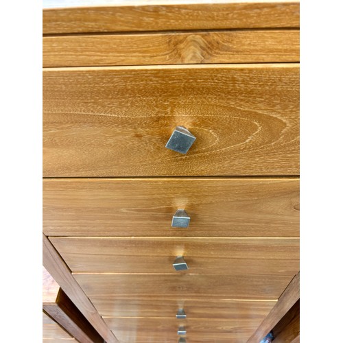165 - A modern teak chest of seven drawers - approx. 119cm high x 55cm wide x 45cm deep