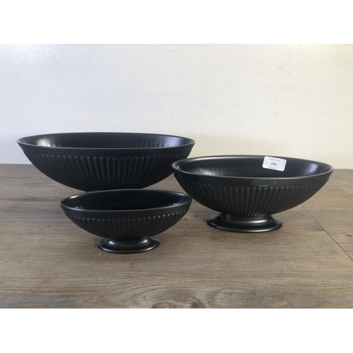 244 - Three Wedgwood black Ravenstone vases - largest approx. 12.5cm high x 32cm wide x 12.5cm deep