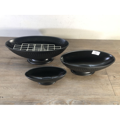 244 - Three Wedgwood black Ravenstone vases - largest approx. 12.5cm high x 32cm wide x 12.5cm deep