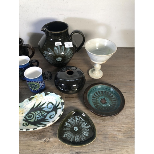 251 - A collection of mid 20th century studio pottery to include John Webb for Lostwithiel Pottery slipwar... 