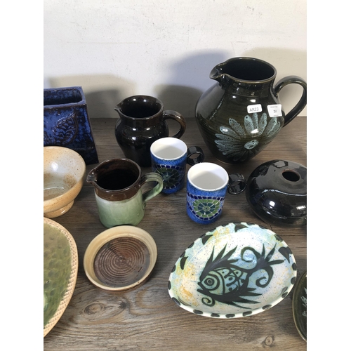 251 - A collection of mid 20th century studio pottery to include John Webb for Lostwithiel Pottery slipwar... 