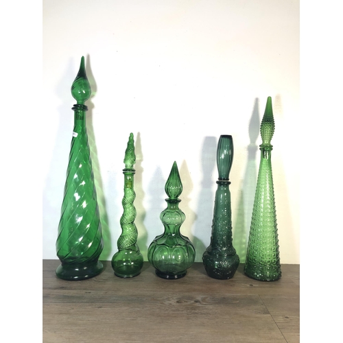 263 - Sixteen pieces of mid 20th century green glassware to include genie bottles, ashtray etc.