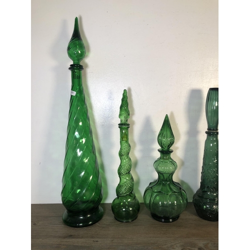 263 - Sixteen pieces of mid 20th century green glassware to include genie bottles, ashtray etc.