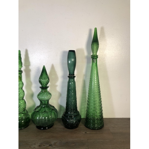 263 - Sixteen pieces of mid 20th century green glassware to include genie bottles, ashtray etc.