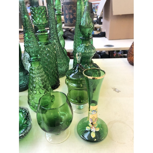 263 - Sixteen pieces of mid 20th century green glassware to include genie bottles, ashtray etc.