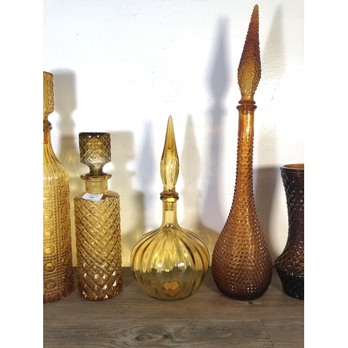 264 - Twenty seven pieces of mid 20th century amber glassware to include genie bottles, centrepiece bowls ... 