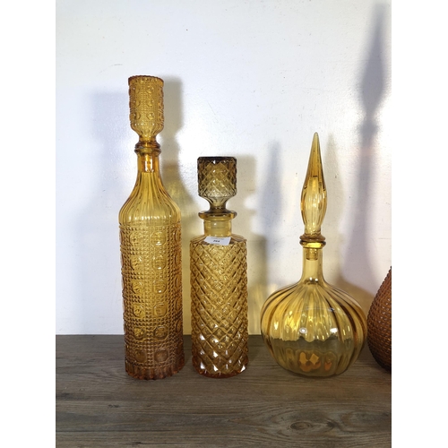 264 - Twenty seven pieces of mid 20th century amber glassware to include genie bottles, centrepiece bowls ... 