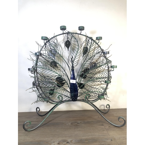 286 - A contemporary metal peacock tealight holder - approx. 66cm high x 64cm wide